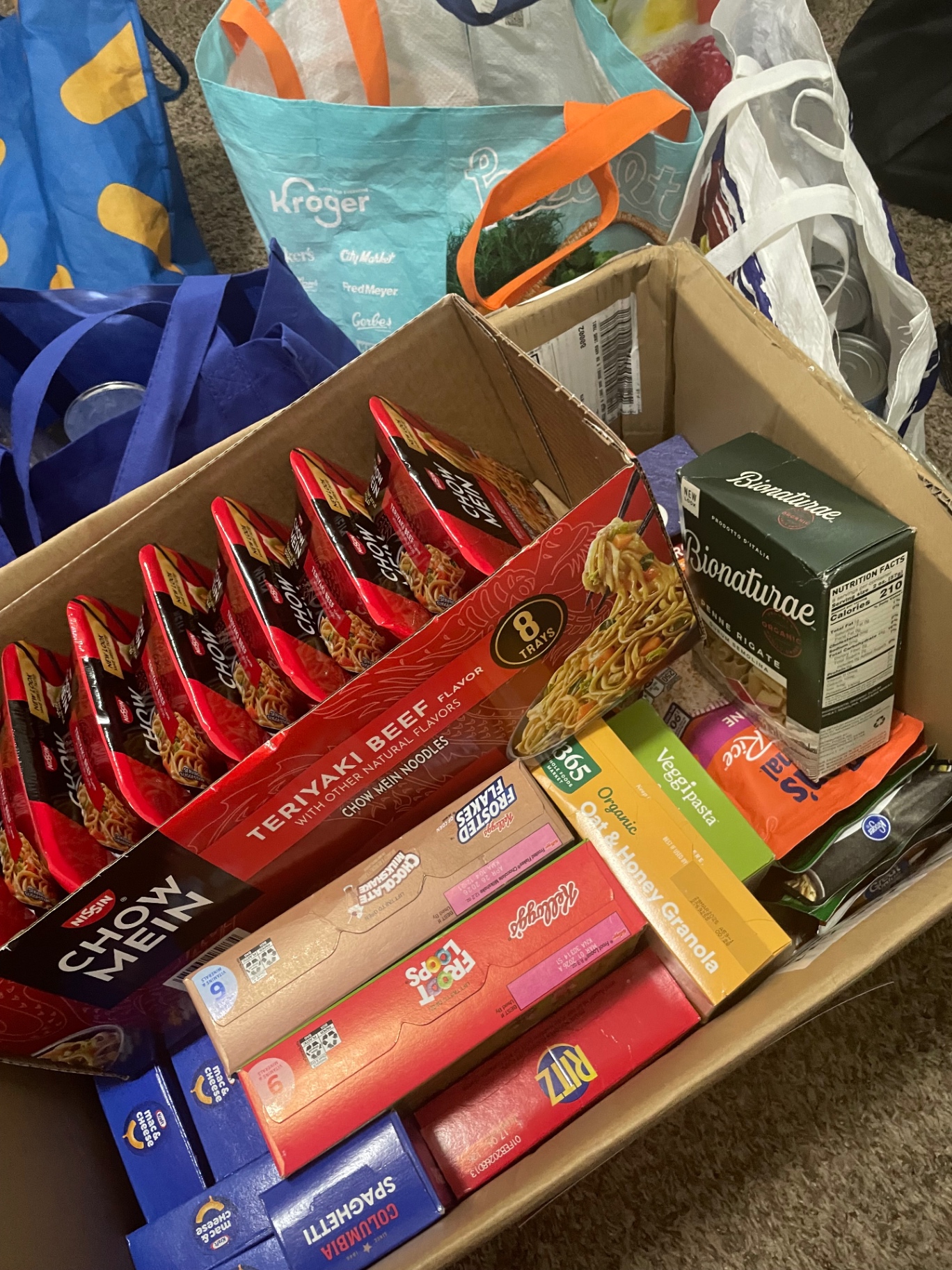 Boxes and reusable bags filled with donated pantry items